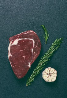 Raw steak, beef steak, rib eye steak, on the table, top view, no people, on a dark background