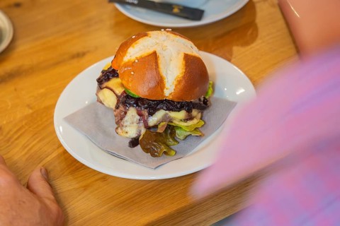 Close-up of a burger on a pretzel bun on a plate, autumn creations, Cafe Kuh, Deckenpfronn, Black
