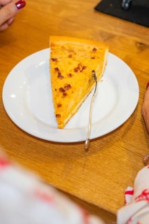 Piece of cake on a plate with a woman ready to eat it with a fork, autumn creations, Cafe Kuh,