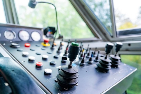 Black control panel with levers and buttons in cabin, Hermann Hesse Bahn track construction, Calw