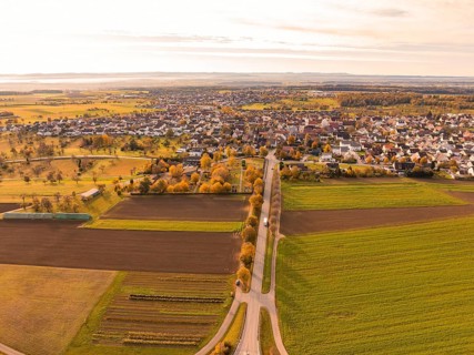 View of a small town surrounded by extensive fields in autumn tones, Jettingen, Black Forest,