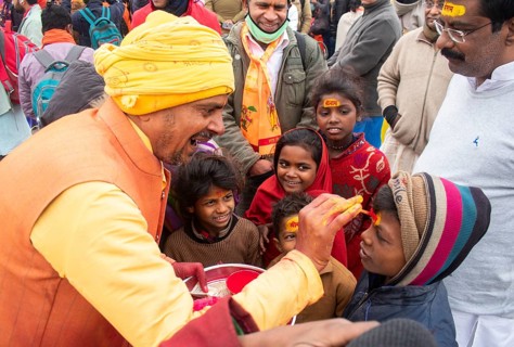 Children get painted the name of Lord Ram on their forehead, on the eve of consecration ceremony of