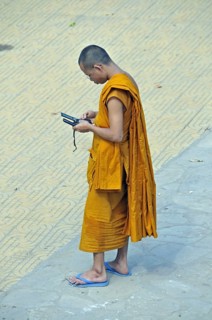 Monk with two mobile phones, Phnom Penh, Cambodia, Asia