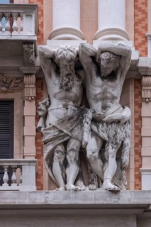 Two atlases on a historic house facade, Genoa, Italy, Europe
