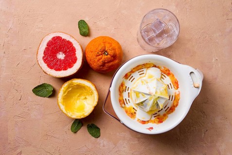 Citrus juicer, sliced fruit, glass with ice, close-up, no people, breakfast