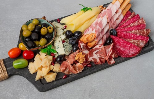Appetizer, assortment, set, sausage, and cheese, on a wooden board, top view, no people