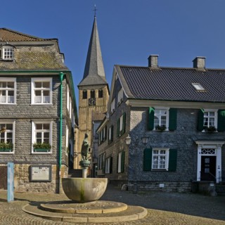 Historic upper town with horse fountain and church tower of St. Lambertus, Mettmann, Bergisches