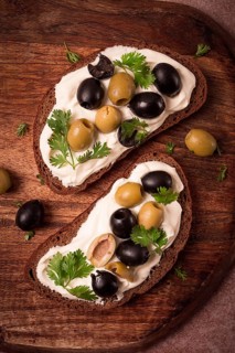 Breakfast, sandwiches, with cream cheese, olives, top view