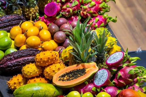 Exotic fruits, lychee, jackfruit, dragon fruit, mango and citrus fruits presented on a table,