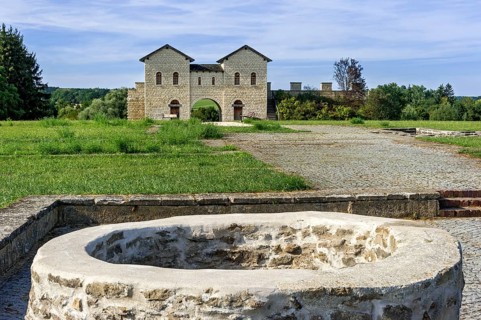 Biriciana Roman fort, fountain in the inner courtyard and reconstructed north gate, Porta decumana,