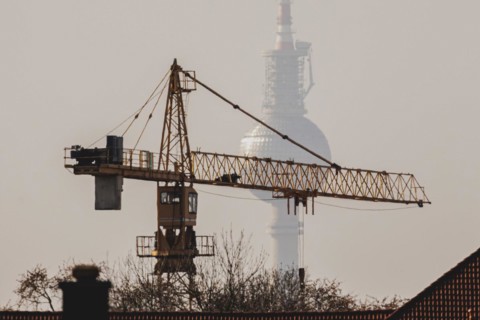 A crane looms in front of the Berlin television tower in Berlin, 29/02/2024