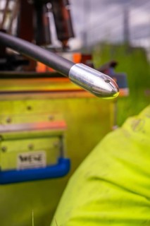 Close-up of a cable with a metal tip while working in a meadow, fibre optic installation, Calw