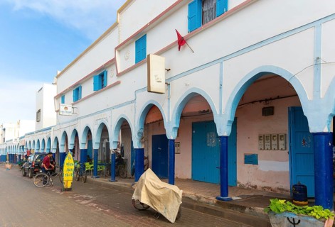 Historic buildings shops and hotel in arcaded shopping street in town centre, Mirleft, southern