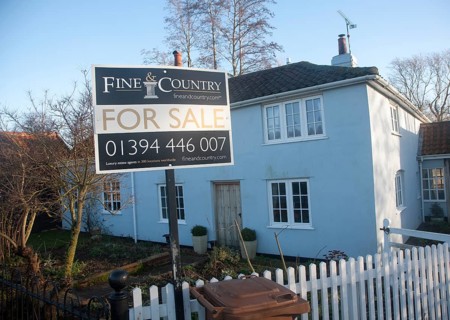 Fine and Country estate agent for sale sign outside detached rural house, Suffolk, England, United