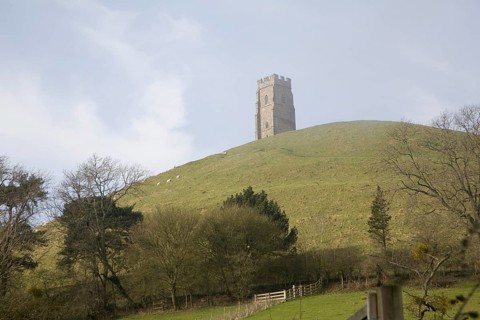 St Michael's Tower on Glastonbury Tor, Somerset, England in misty haze with blue sky