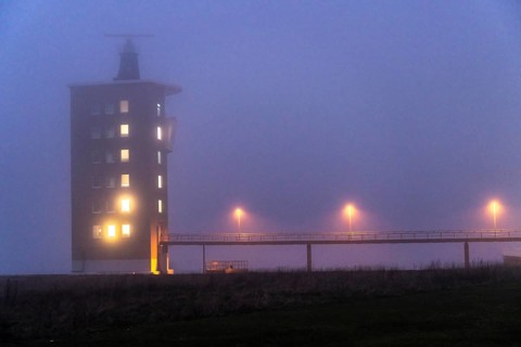 Thick fog in winter, hanging over the mouth of the Elbe into the North Sea, radar tower of the