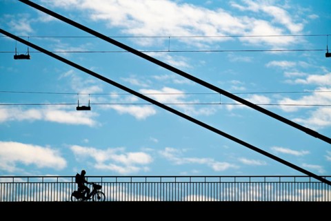 Cyclist, on the Rheinknie Bridge in Düsseldorf, North Rhine-Westphalia, Germany, Europe