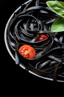 Black pasta coloured with squid ink on a plate, Taglioni al Nero di Seppia, Italy, Europe