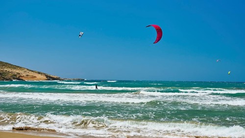 Kitesurfer glides with his kite over the waves of the sea, surfers paradise, kitesurfer,