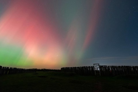 Northern lights (aurora borealis) over the ring sanctuary of Pömmelte, prehistoric circular ditch
