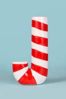 Red and white striped Christmas candy cane on blue background