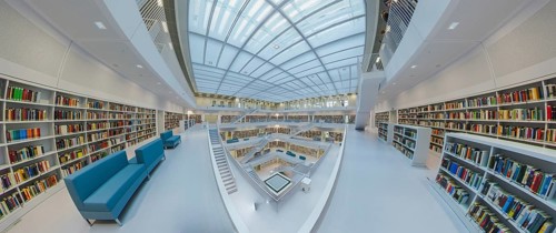 Galeriesaaal, Modern library with glass roof and white stairs, surrounded by bookshelves in a