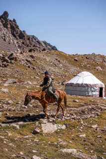 Rider and yurt in the high valley, Keldike Valley on the way to the Ala Kul Pass, Tien Shan
