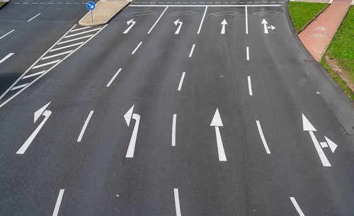 Road markings, turning lanes, directional signage at an intersection, turning, straight ahead,