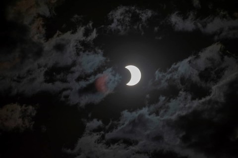 Partial solar eclipse with light cloud cover on 2 October 2024 in Buenos Aires, Argentina, South