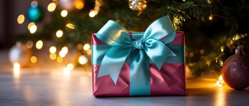 Close-up of a beautifully wrapped Christmas gift with a satin ribbon, set under a glowing Christmas