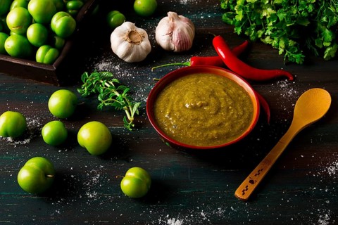 Tkemali sauce, traditional Georgian cuisine, green cherry plum, with ingredients for sauce,
