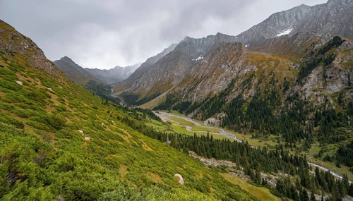 Green mountain valley with river and steep mountain peaks, Chong Kyzyl Suu Valley, Terskey Ala Too,