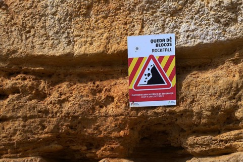 Rockfall, warning sign, danger of falling rocks, unstable cliff, beach, Praia da Dona Ana, Lagos,