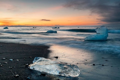 Small icebergs on the beach during sunset, long exposure, Diamond Beach, glacier lagoon Jökulsárlón