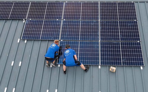 Installation of solar modules on the roof of a barn on a farm, over 240 photovoltaic modules are