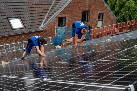 Installation of solar modules on the roof of a barn on a farm, over 240 photovoltaic modules are