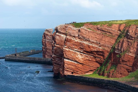 Red coloured sandstone, steep cliff coast of the offshore island of Heligoland, Lange Anna, home of