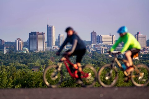Skyline of Essen, city centre, skyscrapers, town hall, RWE tower, mountain bikers on the