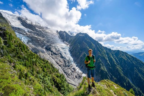 Mountaineer in front of impressive mountain landscape with glacier, view of glacier Glacier de