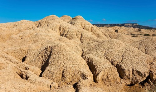 Dry mountain formations in a desert, clear blue sky shows a clear day, Bardenas Reales Natural