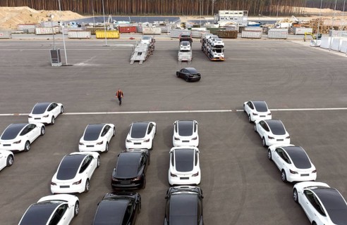 Tesla Y models produced in the Tesla Giga Factory are loaded onto car transporters, Grünheide, 24