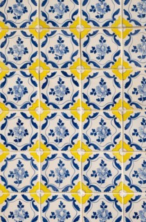 Detailed view of a facade adorned with azulejo tiles on an old house in Porto, Portugal, Europe