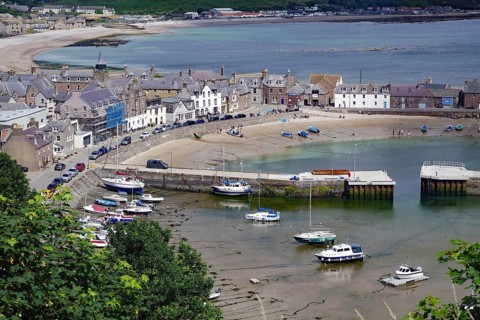 Coastal village with beach, boats and houses surrounded by hills, Stonehaven, Aberdeenshire,