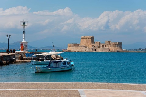 Small fishing boat in front of a historic fortress under blue sky with clouds, Fortress, Bourtz