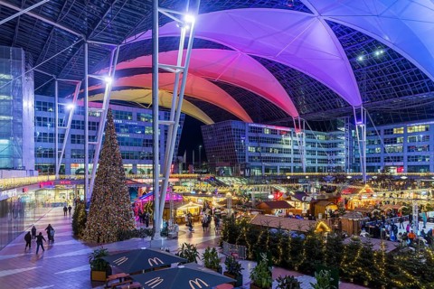 Christmas market at the airport in the evening, market stalls decorated for Christmas in front of