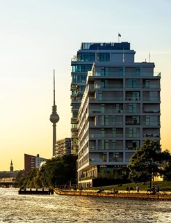 View from the Spree to an apartment building at the East Side Galery and the TV tower on the