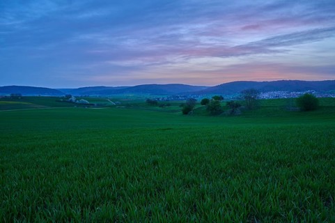 Wide green meadows and hills in the morning light, under a pink-blue sky, Mönchberg, Mltenberg,