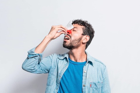Person with irritated nose on isolated background, man with red nose cold, concept of person with