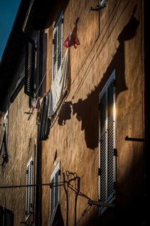 House facade with washing line in the afternoon sun, old town, atmospheric, backlight, sun, evening