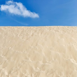 Empty dune, shifting dune, fine sand, spring clouds, minimalist landscape, symbolic image,